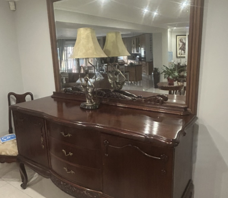Vintage-style mahogany table with ball and claw legs and eight upholstered chairs. With French High-leg XV Antique sideboard and Chest of drawers