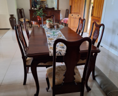 Vintage-style mahogany table with ball and claw legs and eight upholstered chairs. With French High-leg XV Antique sideboard and Chest of drawers