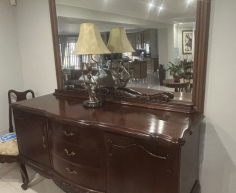 Vintage-style mahogany table with ball and claw legs and eight upholstered chairs. With French High-leg XV Antique sideboard and Chest of drawers